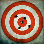 targetBulletHoles Target with a cluster of bullet holes around the bulls eye.